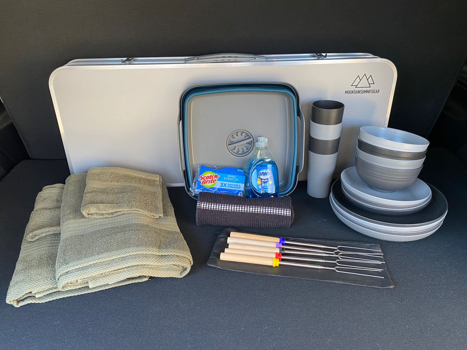 and mesh screen for comfortable outdoor stays.|Ready for adventure! Inside view of an RV rental campervan with a bed & pop-top tent