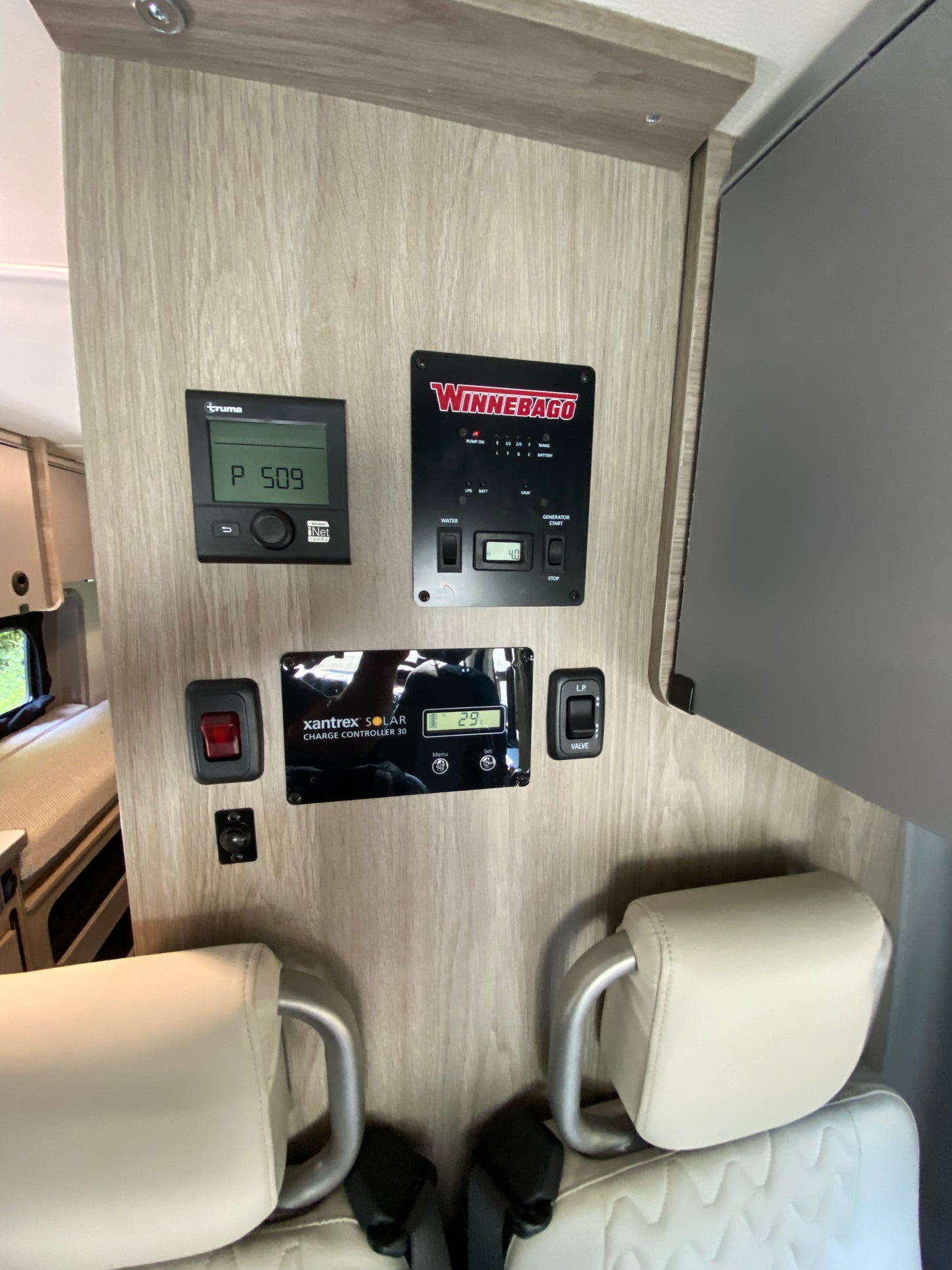 RV rental interior shows a Winnebago control panel, Truma heating, and Xantrex solar charge controller for systems monitoring.