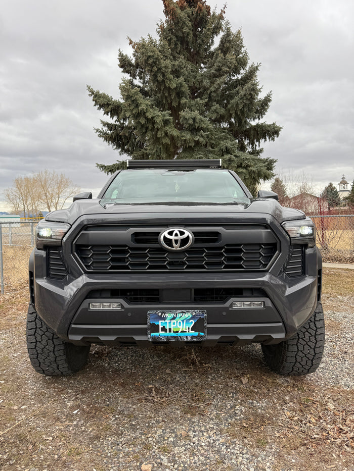 Front view: rugged dark gray Toyota pickup truck with light bar, Montana plate. An ideal rv rental for adventure.