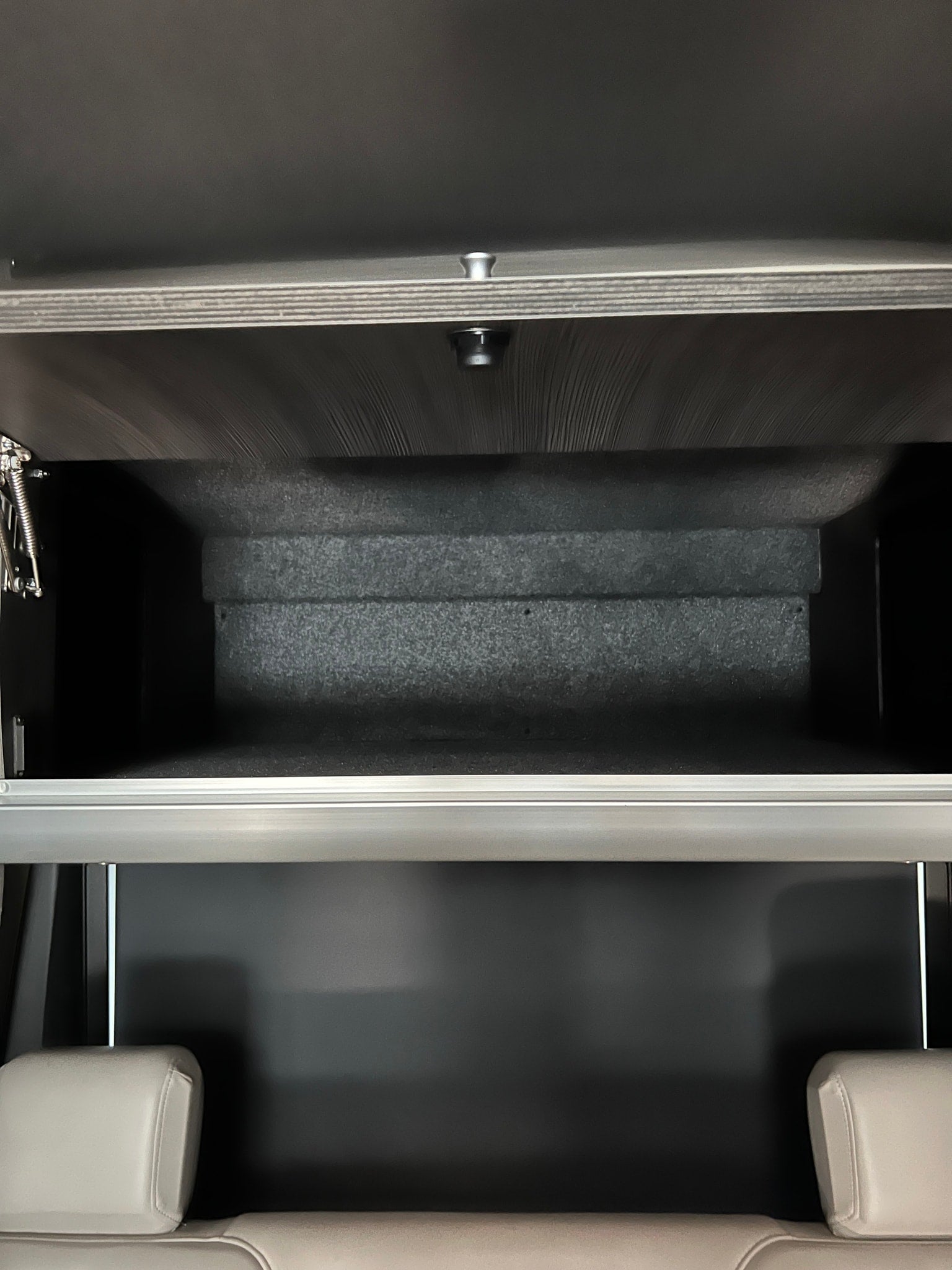 and wooden floor mat.|RV rental: White van with two colorful cruiser bikes on a rear rack