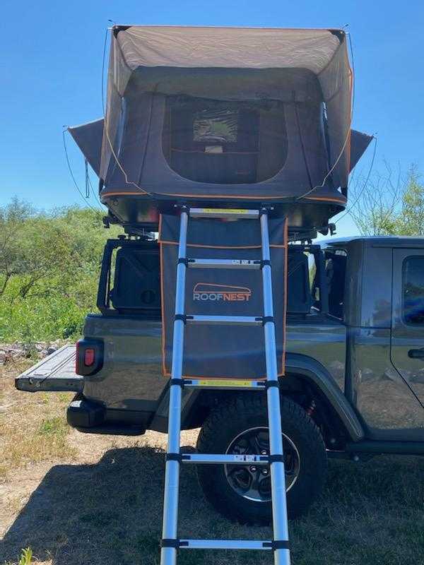 first aid.|An overlanding rig: grey Jeep with a rooftop tent