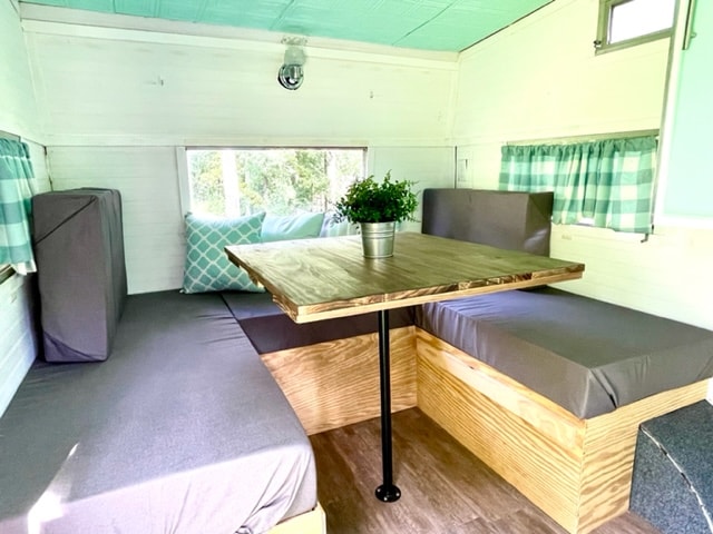 and light teal decor.|Experience comfort in this RV rental's mint green & white interior