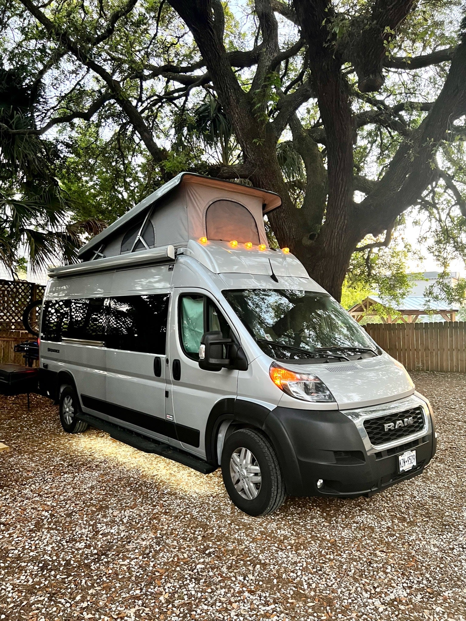 This sleek silver pop-top camper van