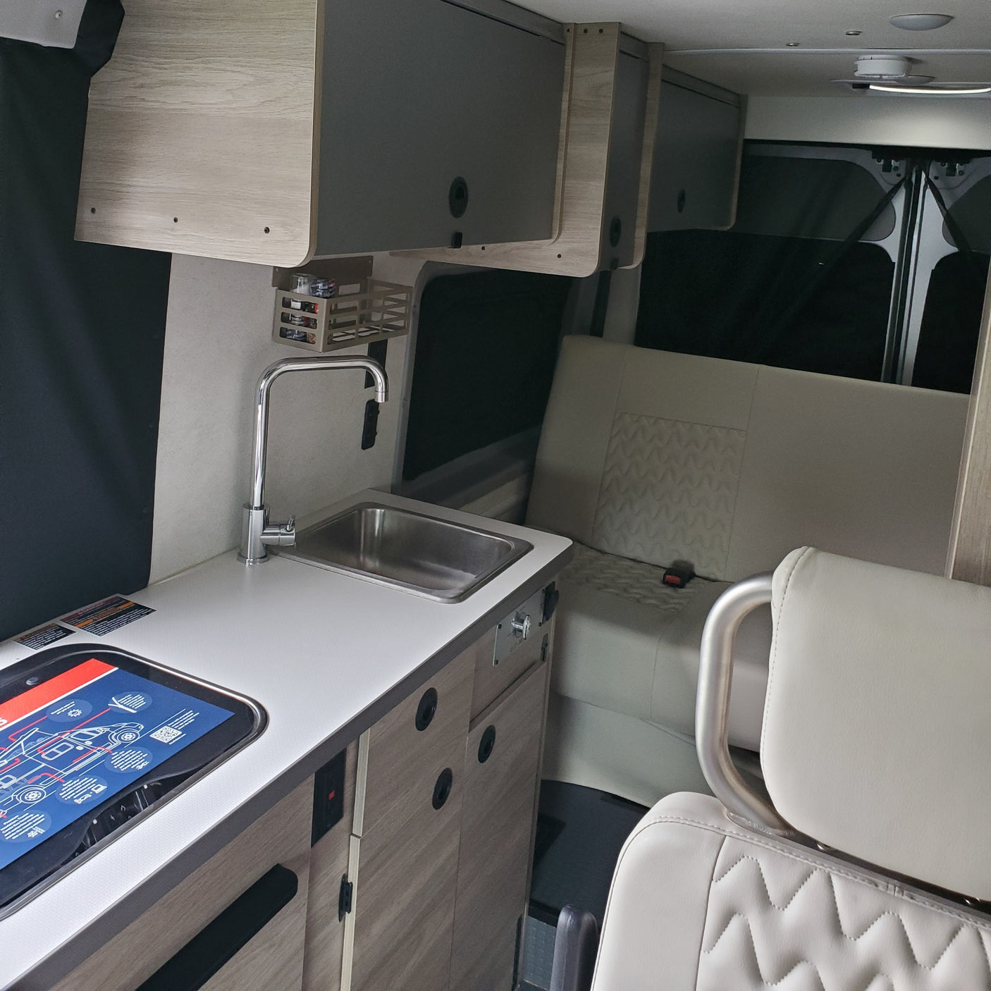 with a dog "driving" and a person visible inside.|Celebrating a new rv rental! A smiling couple poses with their silver Winnebago Solis camper van.|Winnebago Solis RV rental: A happy dog inside a cozy camper van