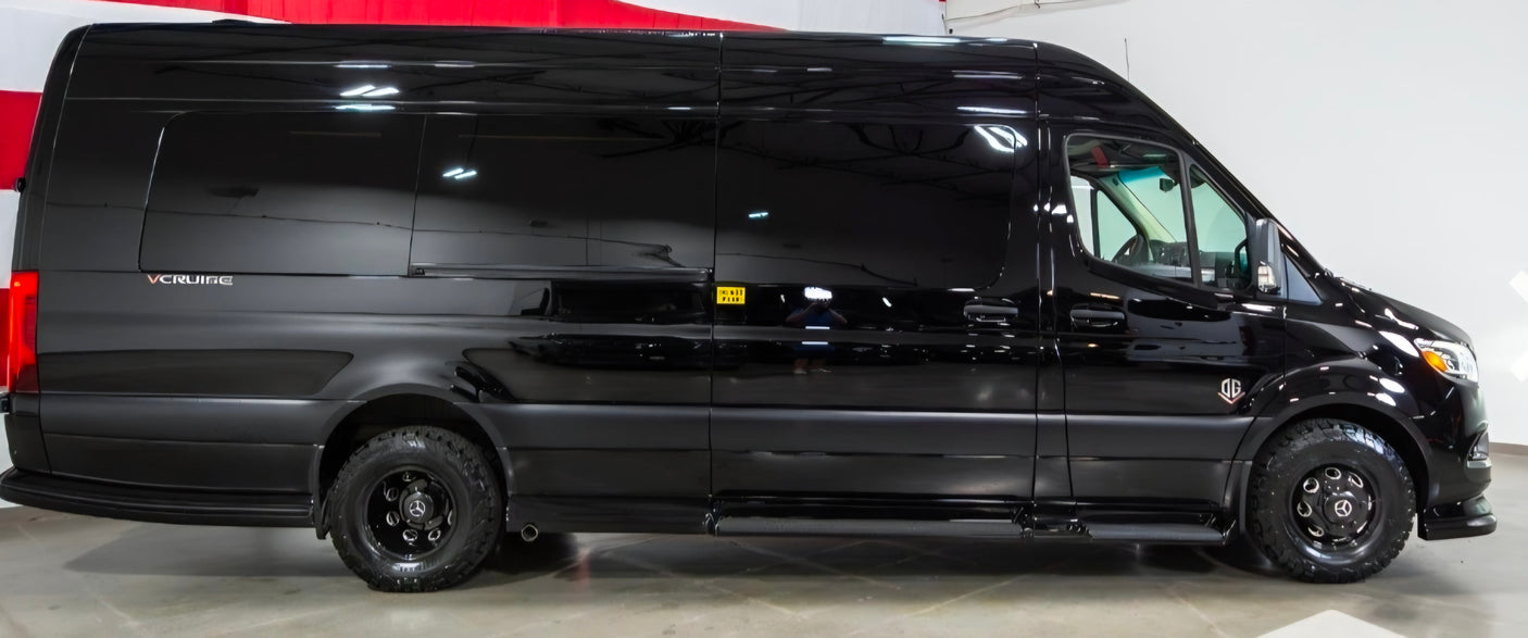 This sleek black Mercedes-Benz Sprinter van is a perfect RV rental, featuring rugged off-road tires.