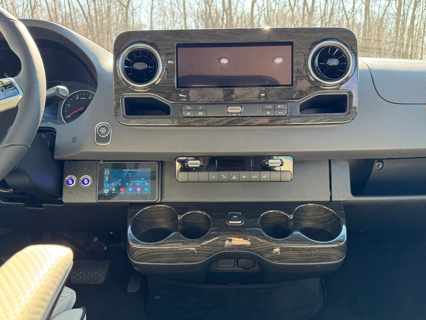 seen from the rear.|Two rows of facing quilted leather seats in a luxury rv rental