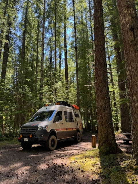 kicks up dust on a desert dirt road.|Mercedes Sprinter RV rental van