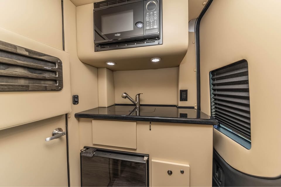 comfortable travel.|Luxury rv rental interior: plush beige leather captain's chair with footrest
