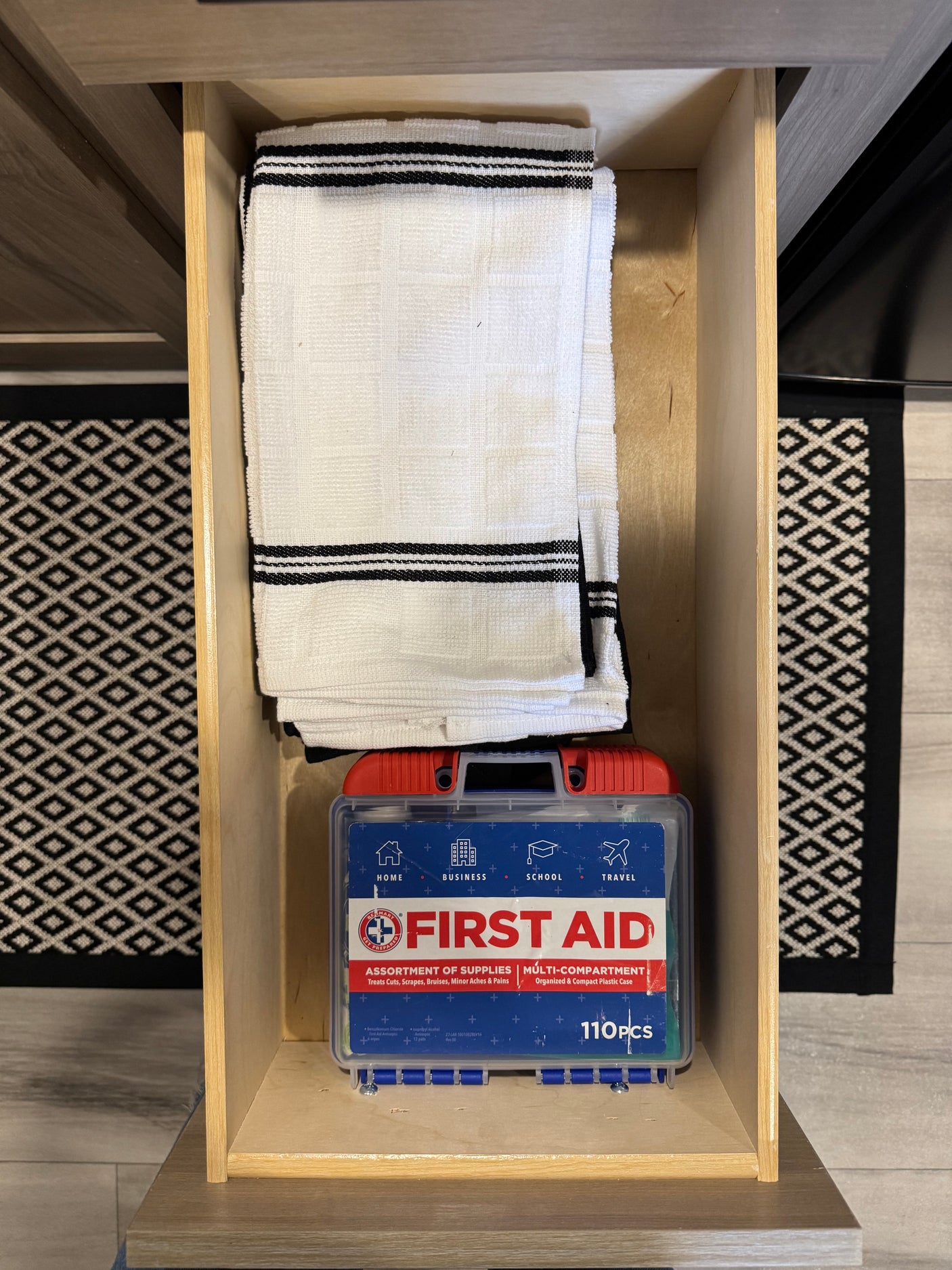 RV rental drawer: folded towels and a 110-piece multi-purpose first aid kit, ready for home or travel.