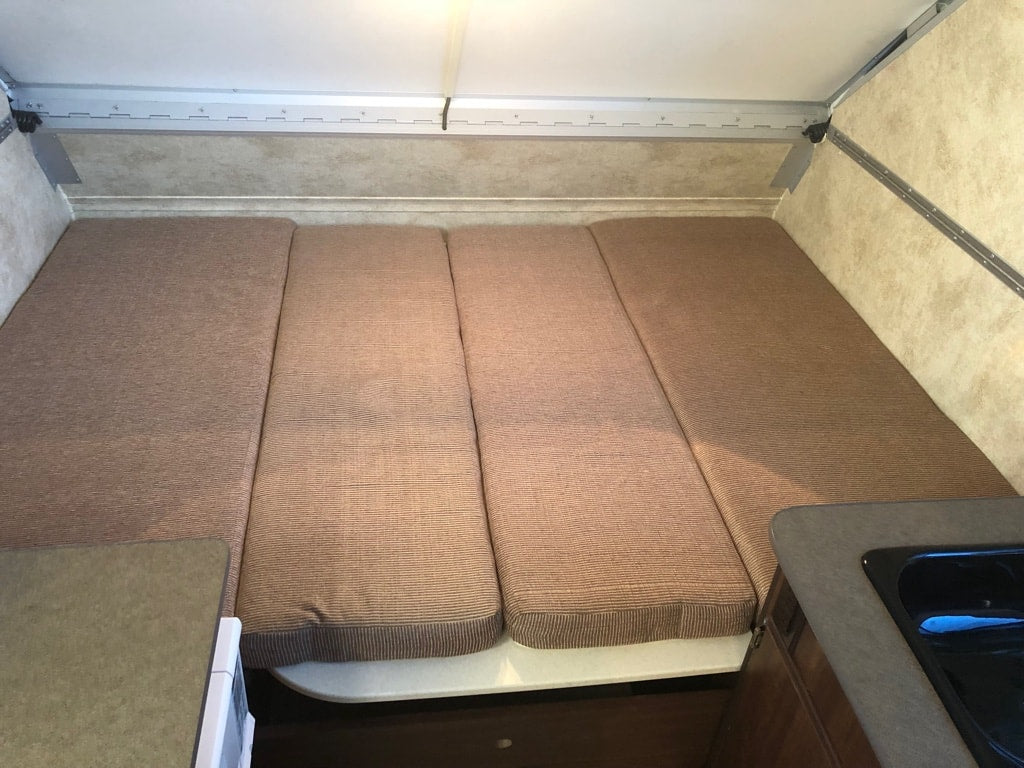 and power hookup.|Explore this cozy A-frame camper RV rental interior! Features a compact kitchenette
