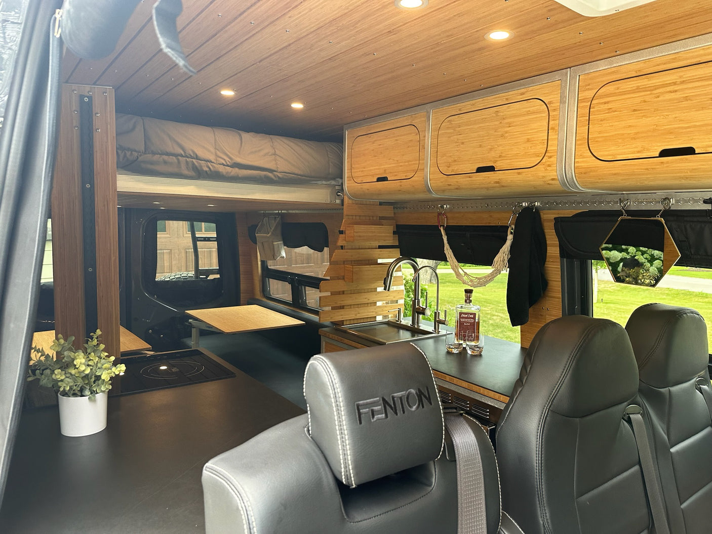 and elevated bed.|Inside this RV rental: a compact kitchen