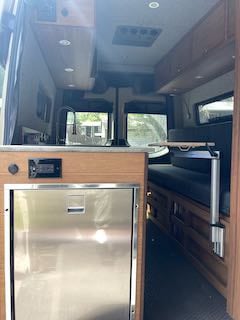 and overhead storage.|RV rental interior with a bright beach view