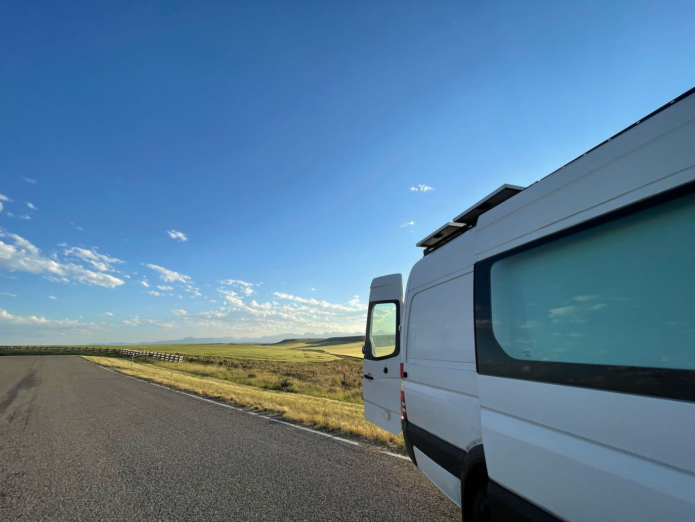 with distant mountains. Perfect for an RV rental road trip!|View from an RV rental driver's seat: Dashboard with JVC stereo & controls