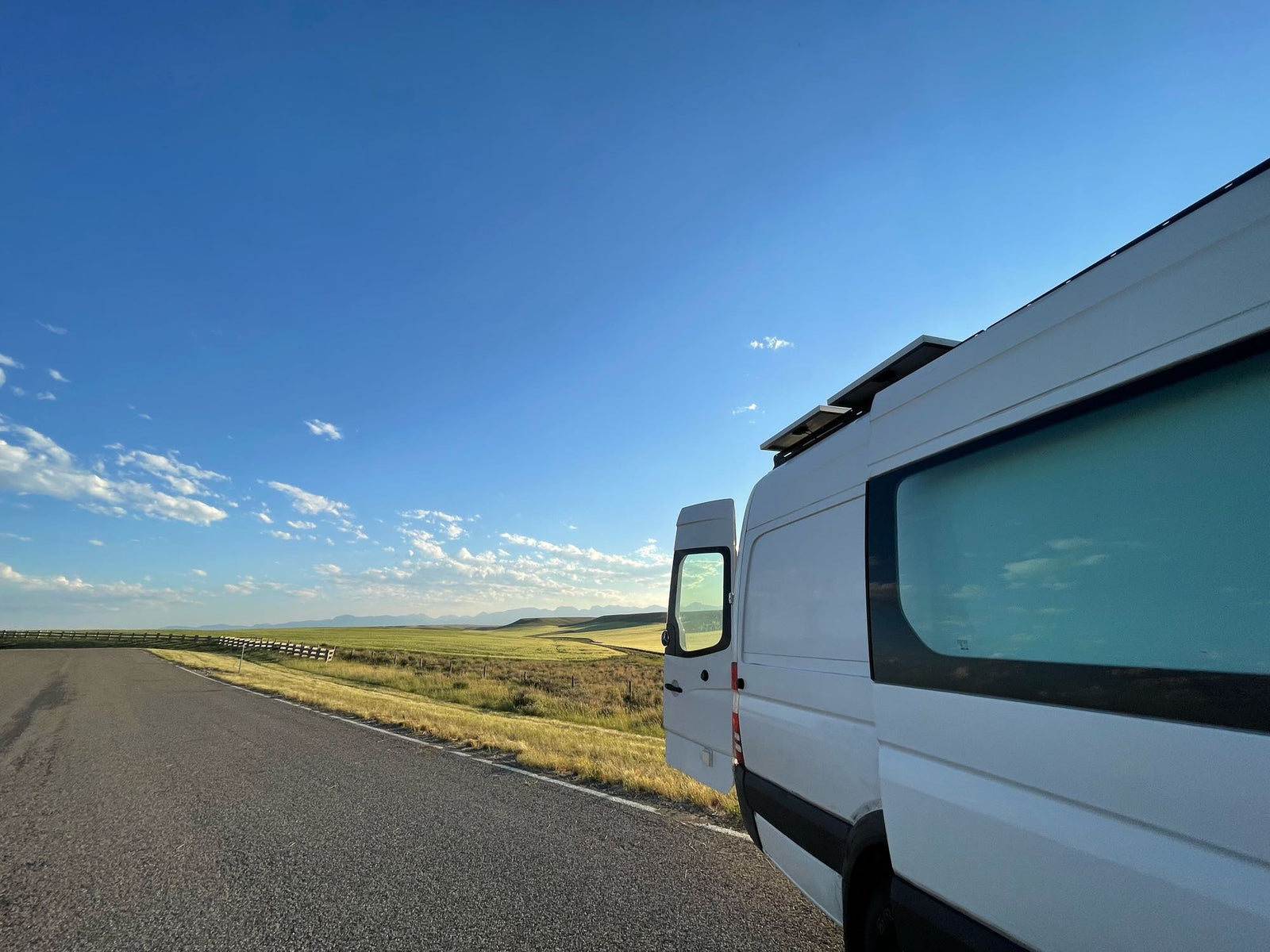 with distant mountains. Perfect for an RV rental road trip!|View from an RV rental driver's seat: Dashboard with JVC stereo & controls