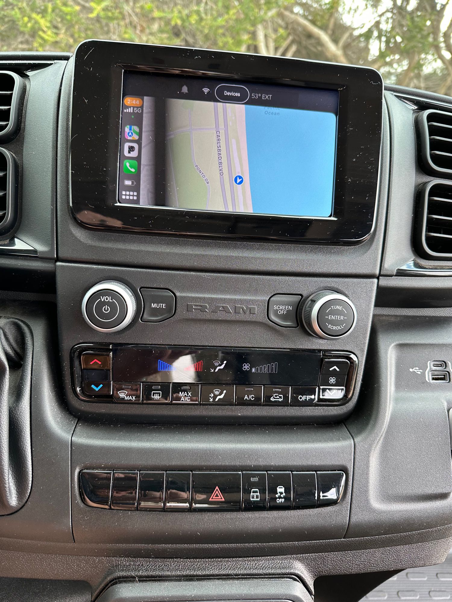 RV rental dashboard with digital infotainment screen showing navigation, climate controls, and console buttons.