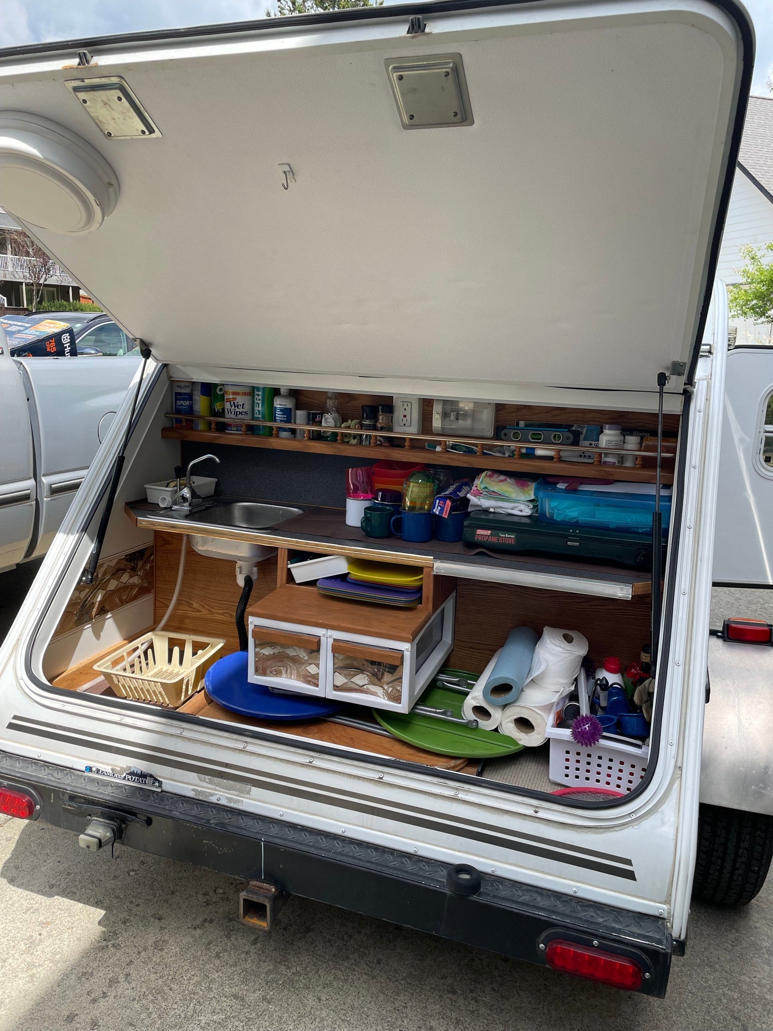 and essential safety items.|Inside an RV rental: a comfortable bed with a pinecone quilt