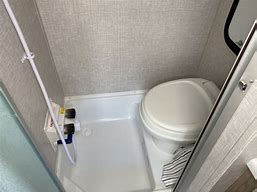 and ample storage for comfortable travels.|RV rental interior: Compact kitchen with stainless fridge