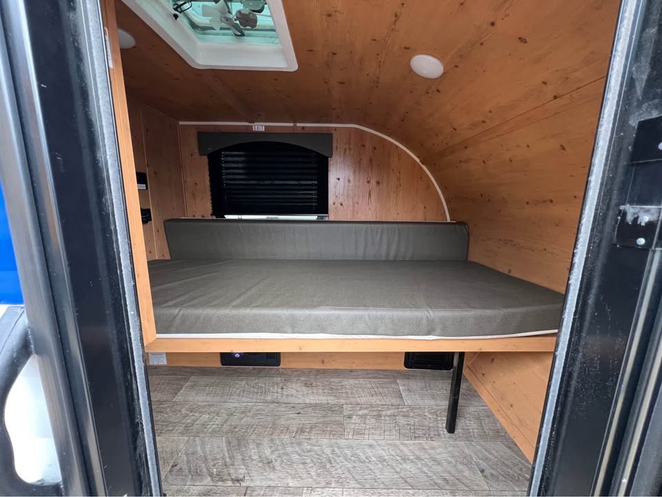 ideal for rv rental. Compact RV with off-road tires.|Compact outdoor kitchen of an RV rental: complete with sink