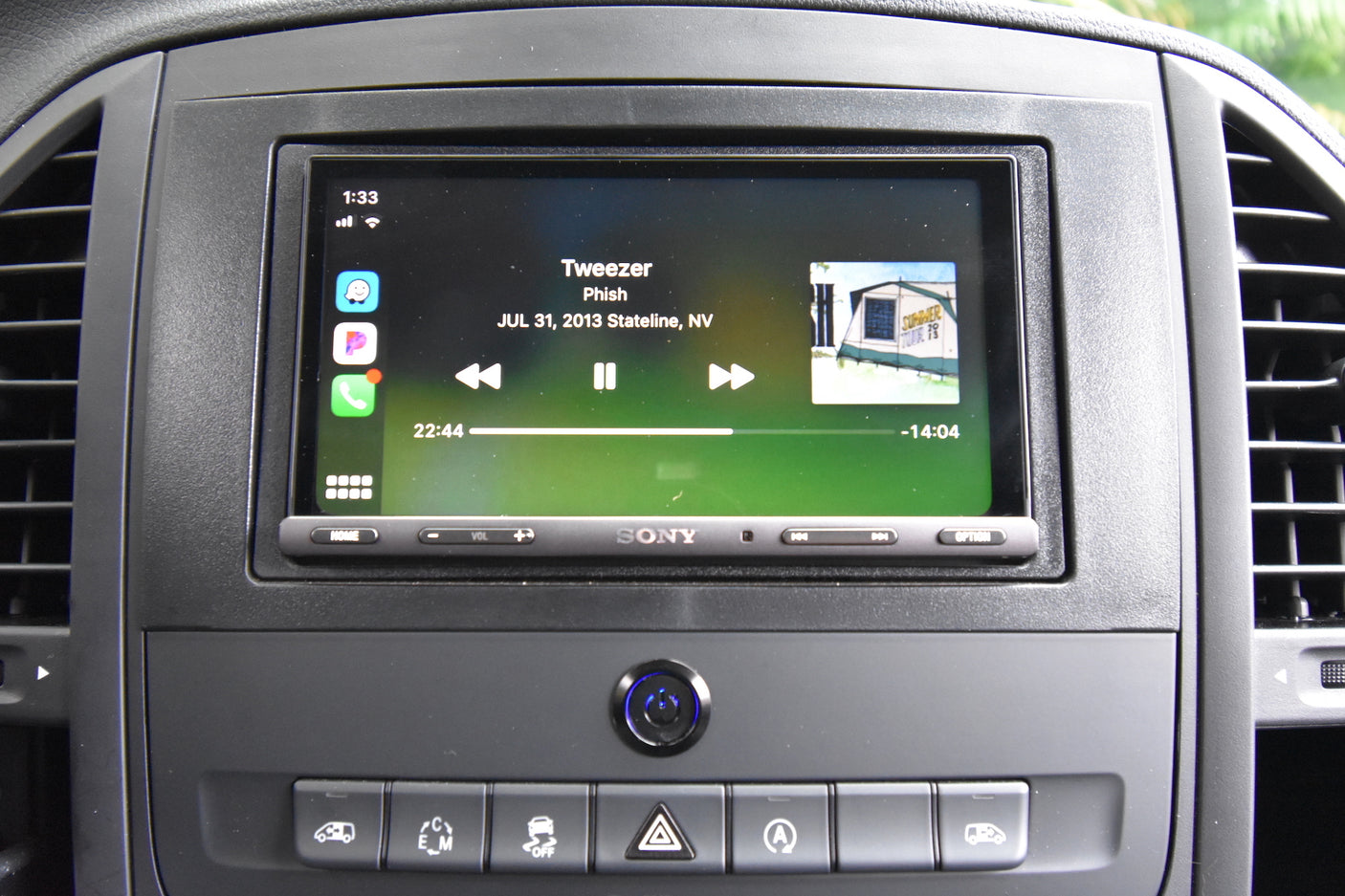 RV rental dashboard with a Sony car stereo running Apple CarPlay, displaying Phish's "Tweezer" live. Ideal for travel entertainment.
