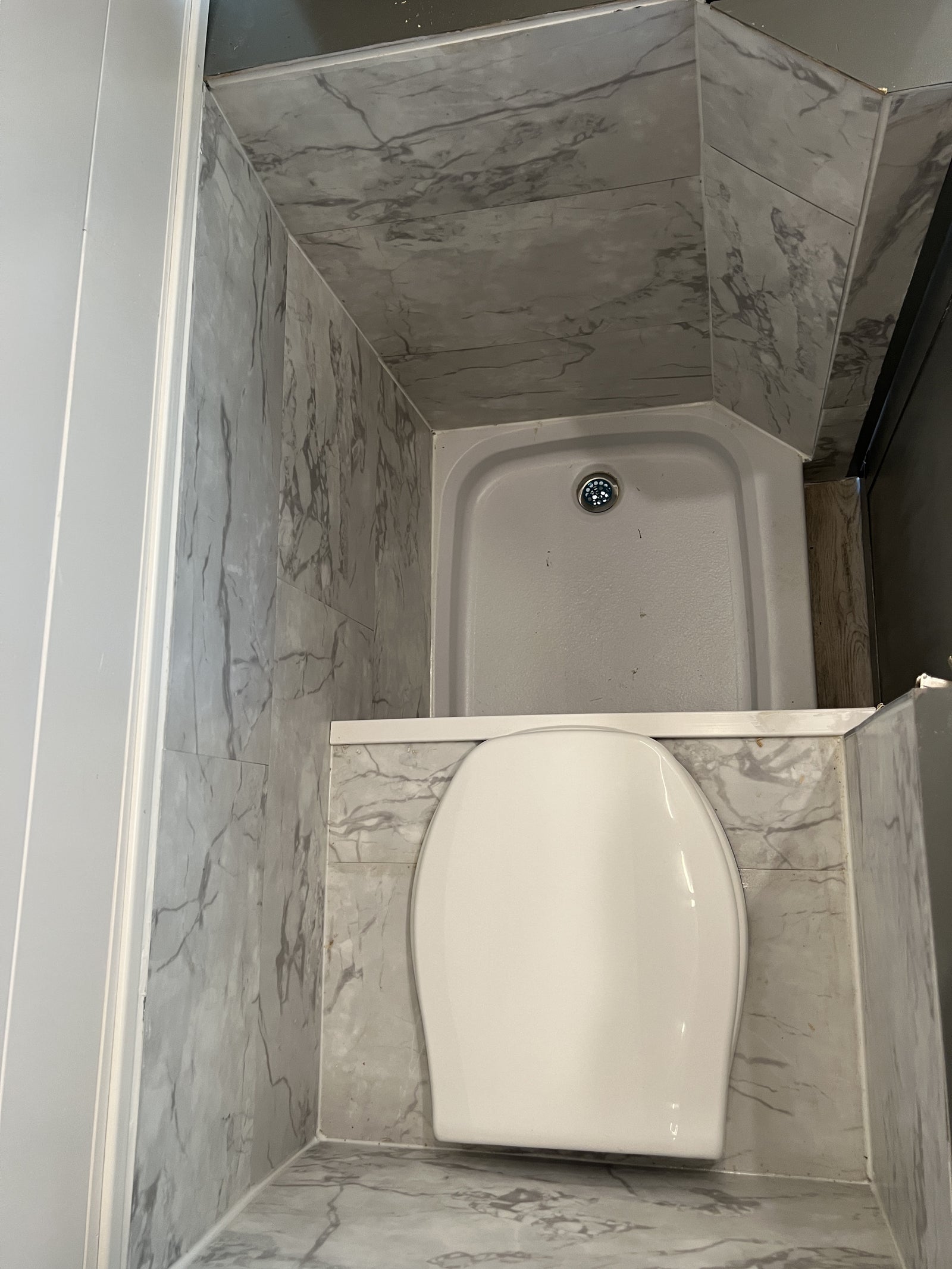 and comfortable seating.|Inside an RV rental: a compact kitchen featuring a sleek black faucet