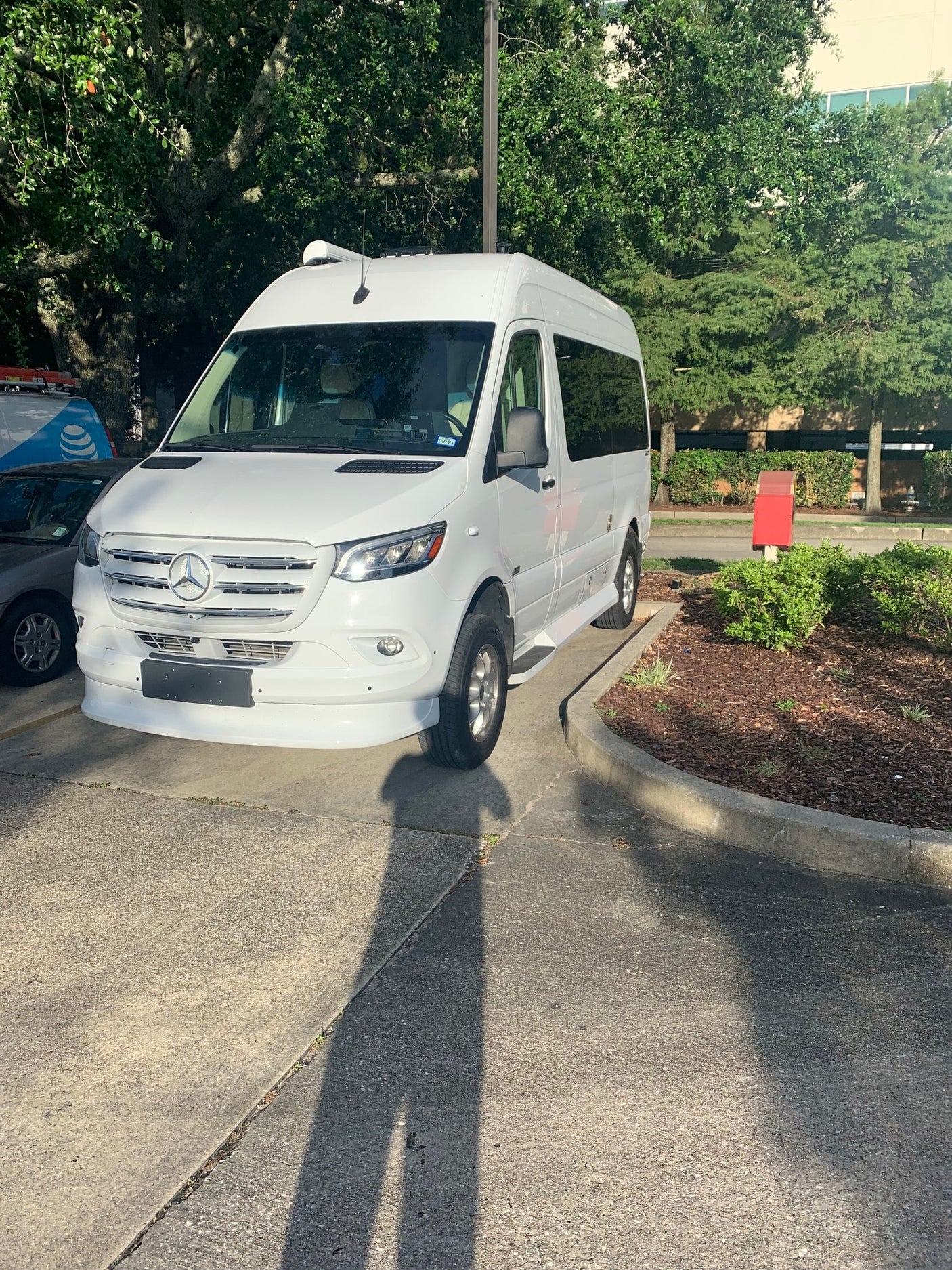 A white Mercedes-Benz Sprinter van