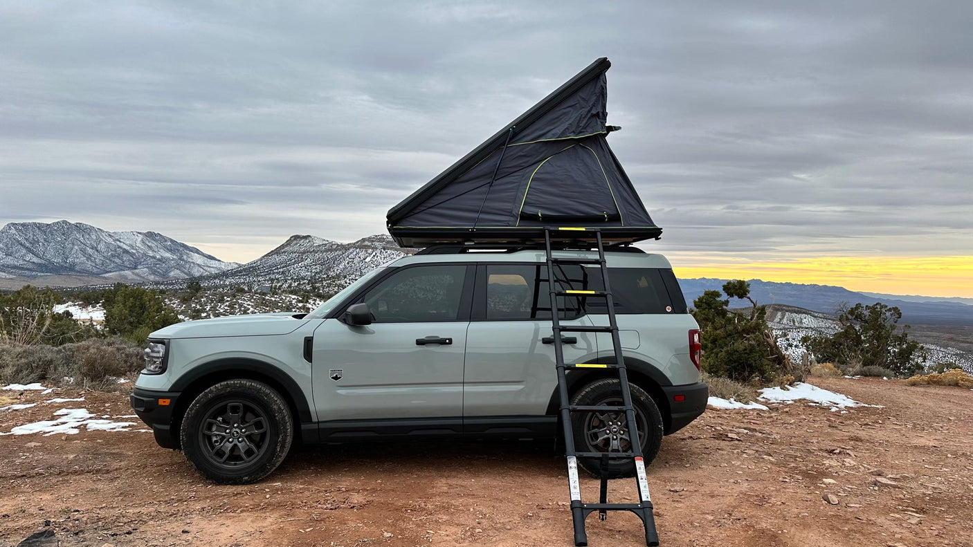 an alternative to RV rental.|Light grey Bronco Sport with deployed roof-top tent and ladder