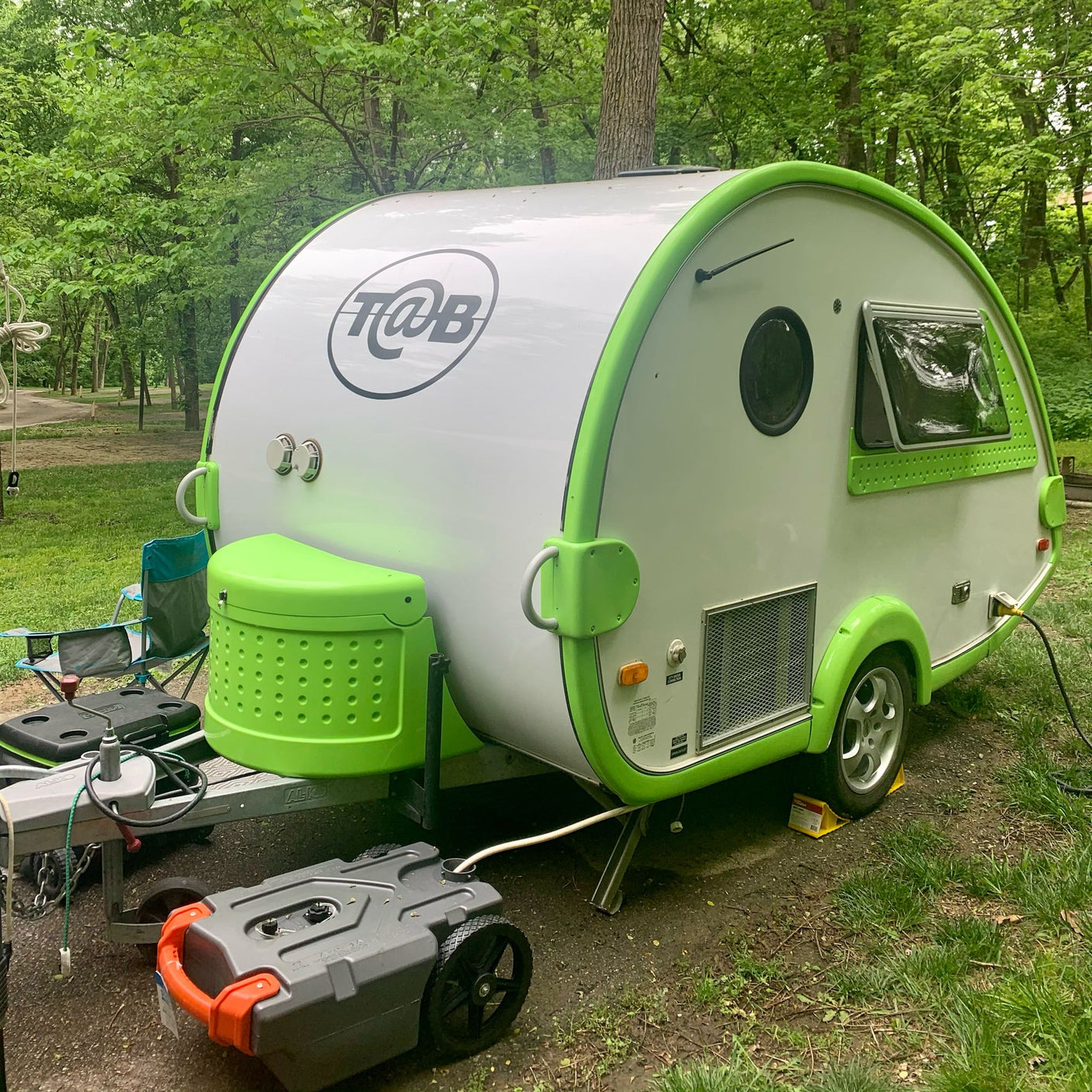 and wood cabinets.|Compact RV rental interior with a functional kitchen featuring a sink