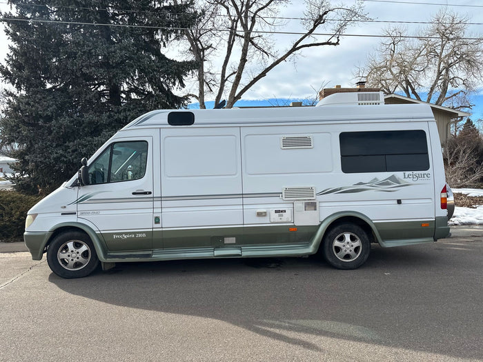 and outdoor mat.|Sunny day with a white Leisure Travel rv rental