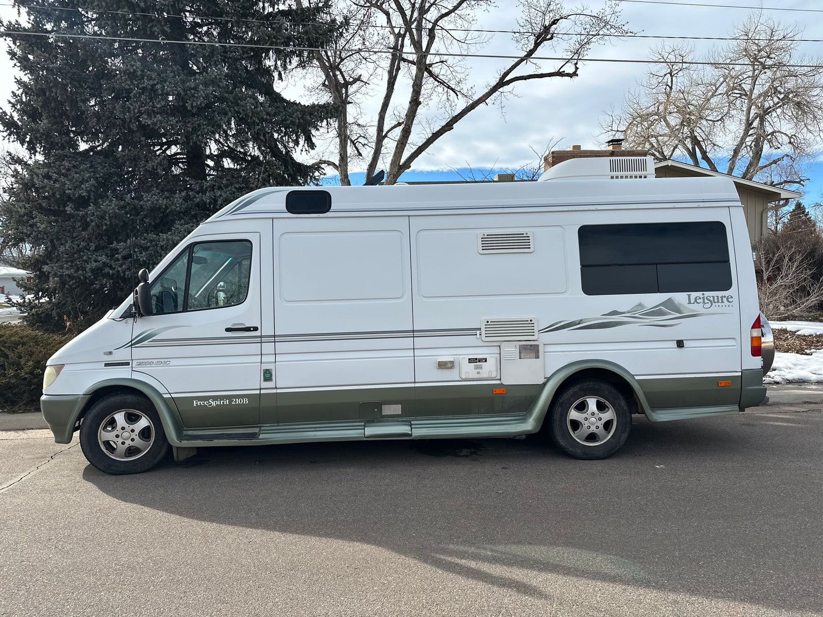 and outdoor mat.|Sunny day with a white Leisure Travel rv rental
