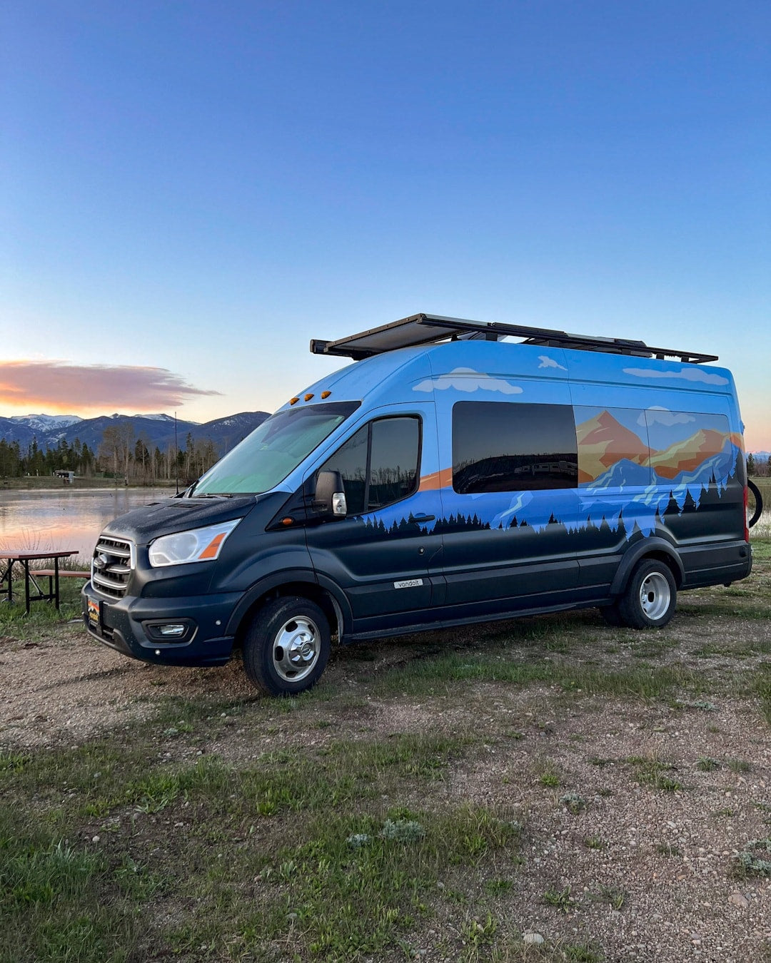 Blue RV rental campervan with mountain mural