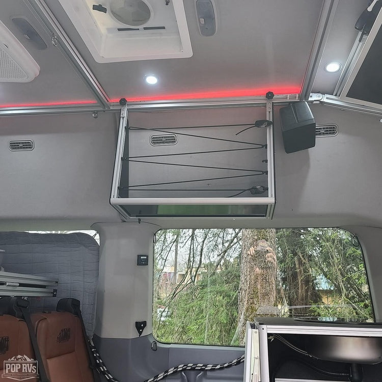 Explore this RV rental's organized interior: overhead storage with bungee cords, bright and ambient lighting for comfortable travel.