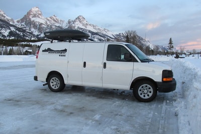 White Basecamper van RV rental with roof box, parked in snowy terrain near majestic mountains, ideal for winter trips. — photo 7