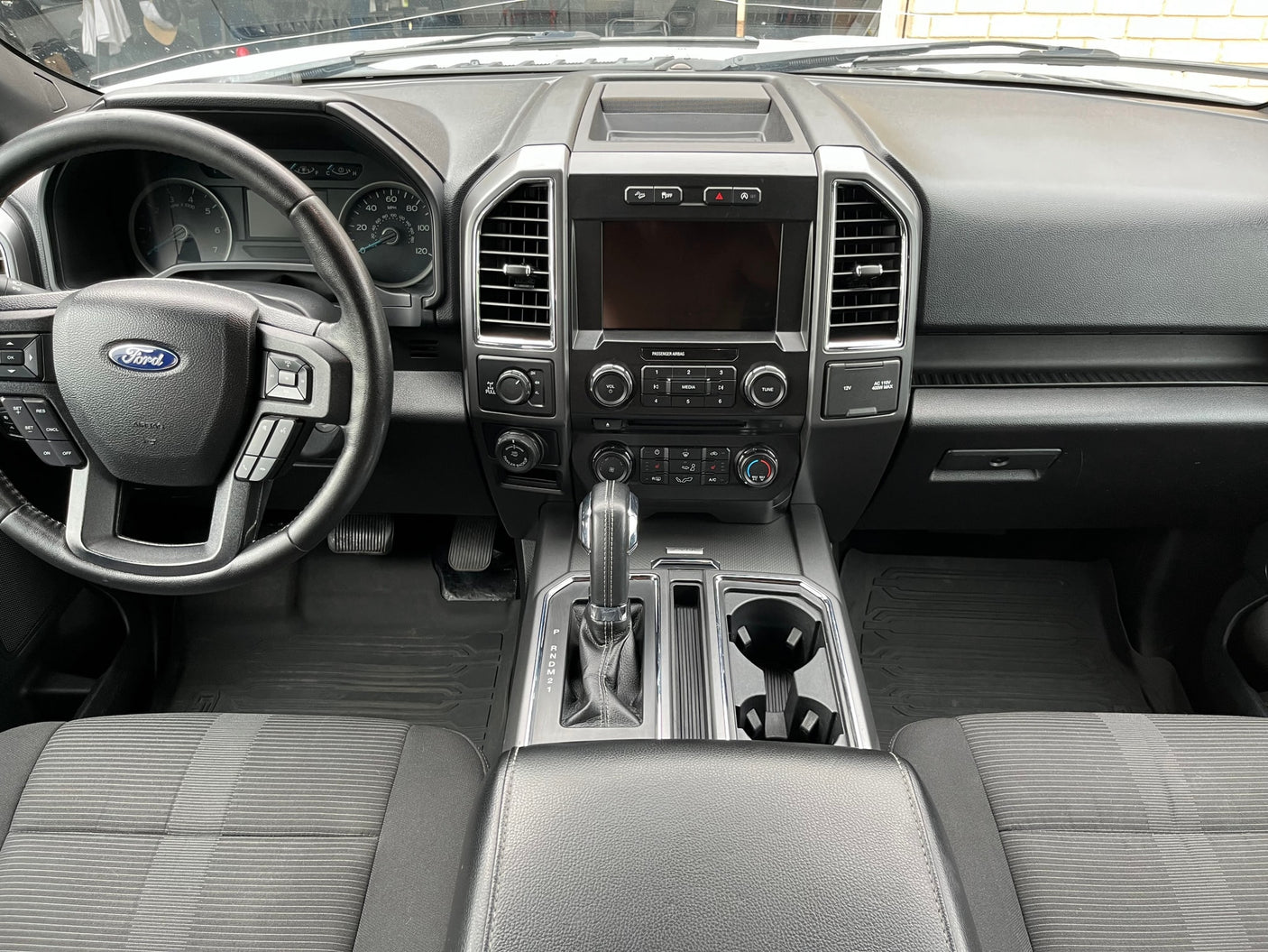 Clean Ford truck interior, showing dashboard, steering wheel, and console. Perfect for a comfortable rv rental adventure.