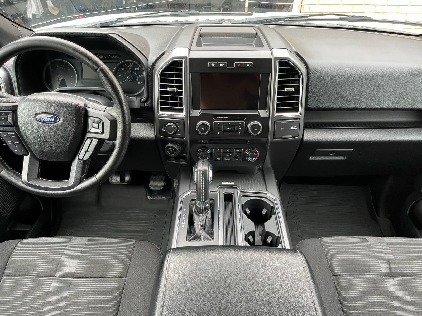 Clean Ford truck interior, showing dashboard, steering wheel, and console. Perfect for a comfortable rv rental adventure.