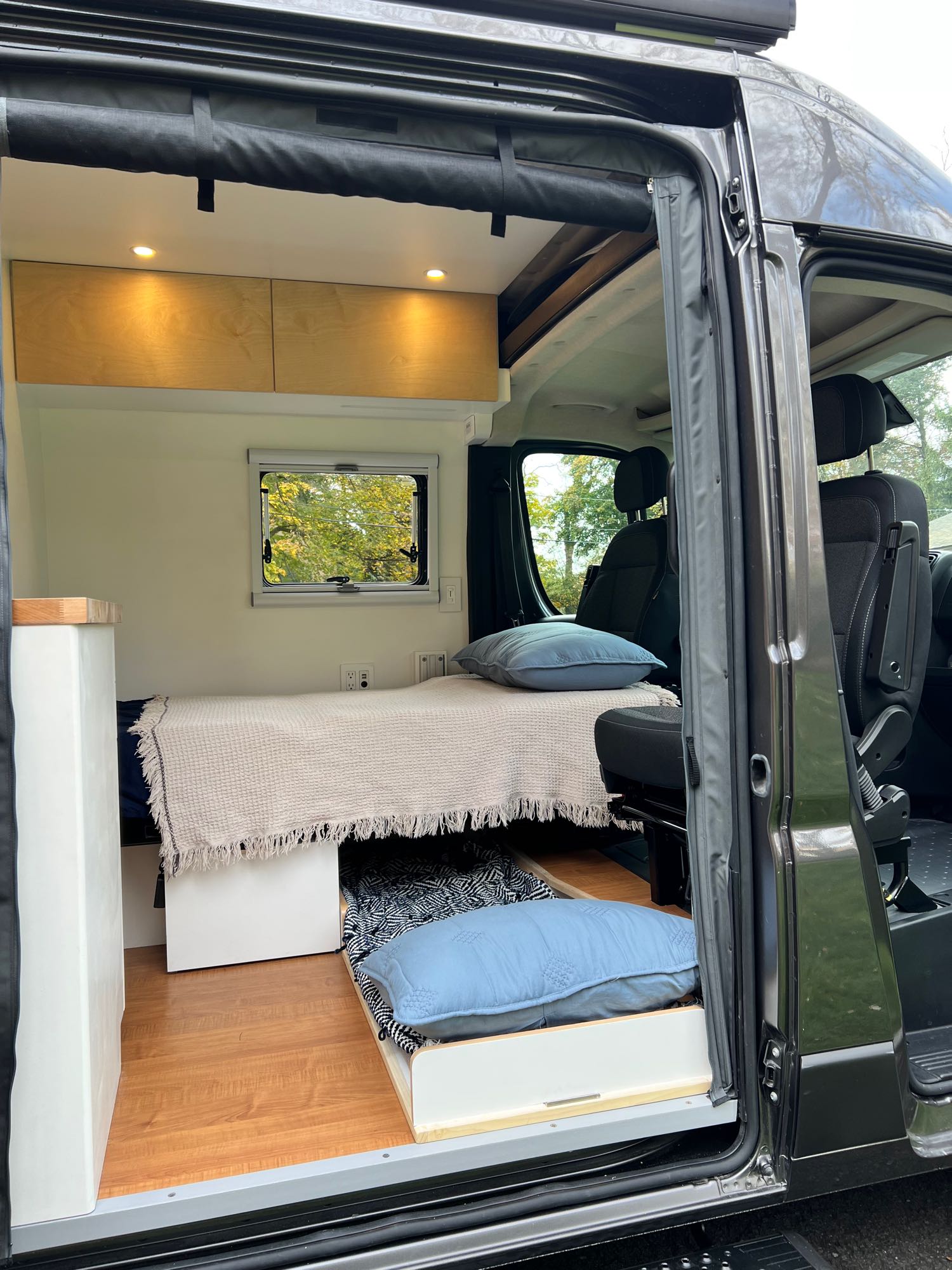 and a portable toilet. Perfect for road trip comfort.|RV rental: Compact interior with a raised bed