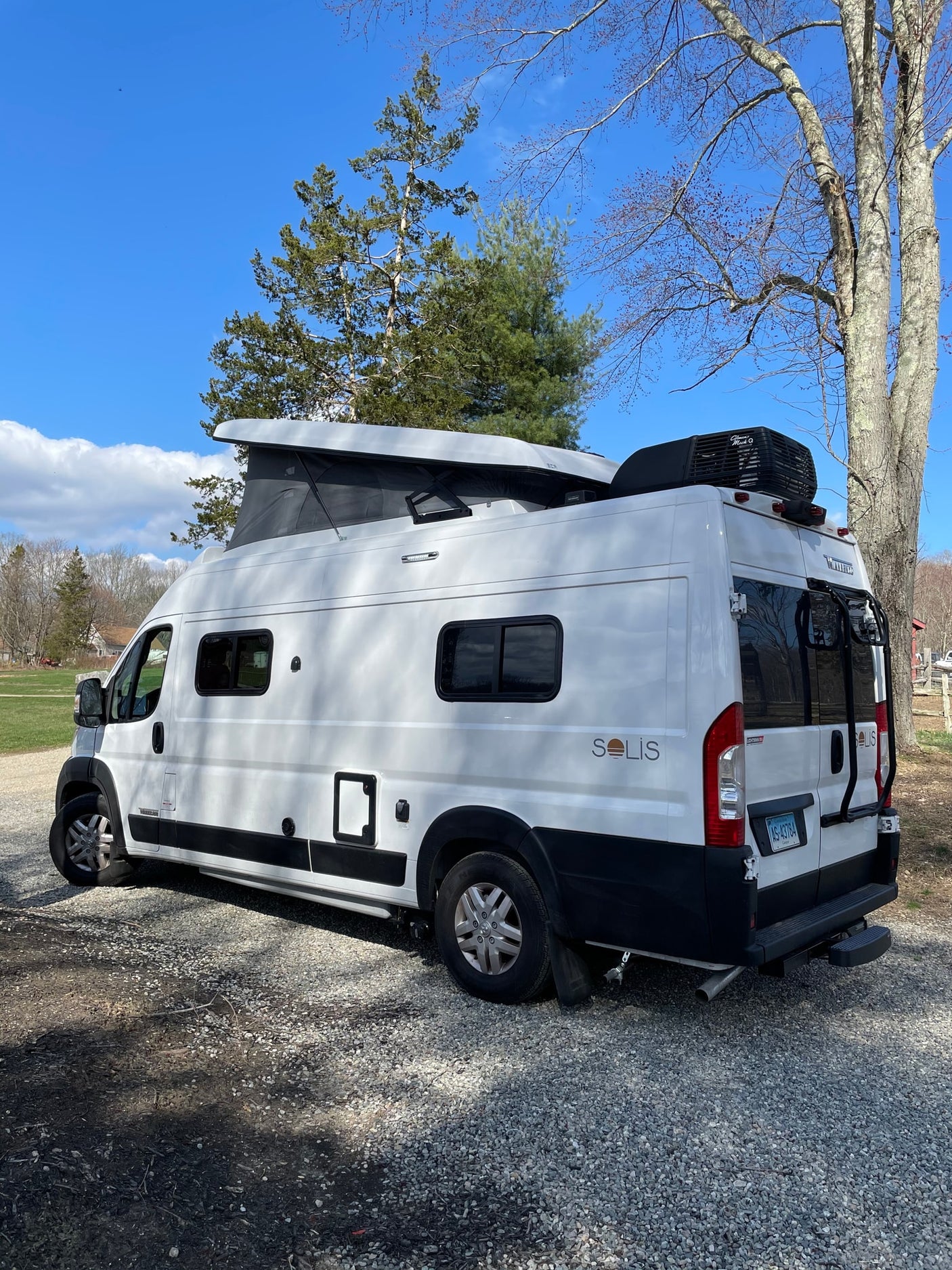 White Winnebago Solis camper van with pop-top extended