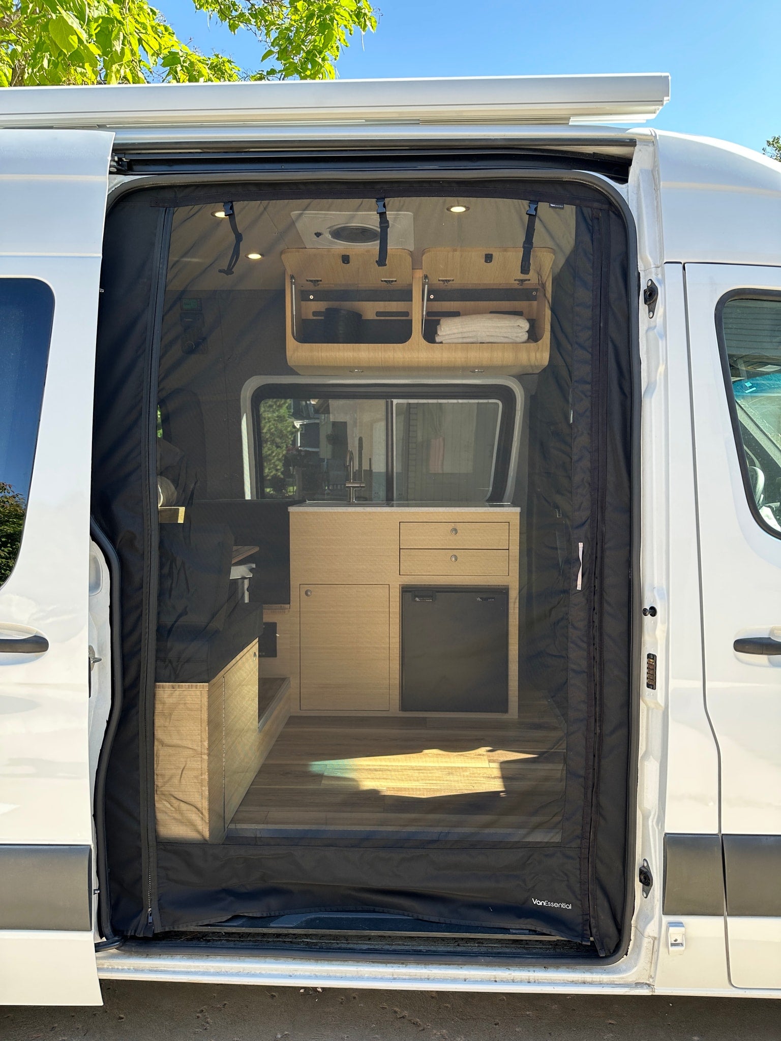 and compact kitchen featuring a sink.|Modern RV rental interior: bamboo cabinetry