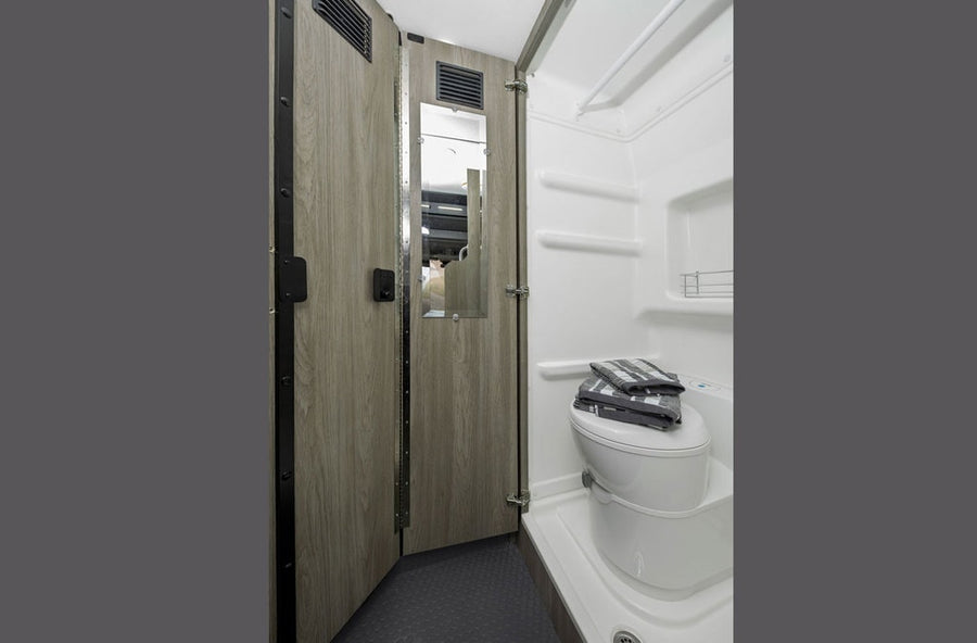 and functional screen.|Explore a comfortable RV rental: rear view of a camper van's organized interior with open doors