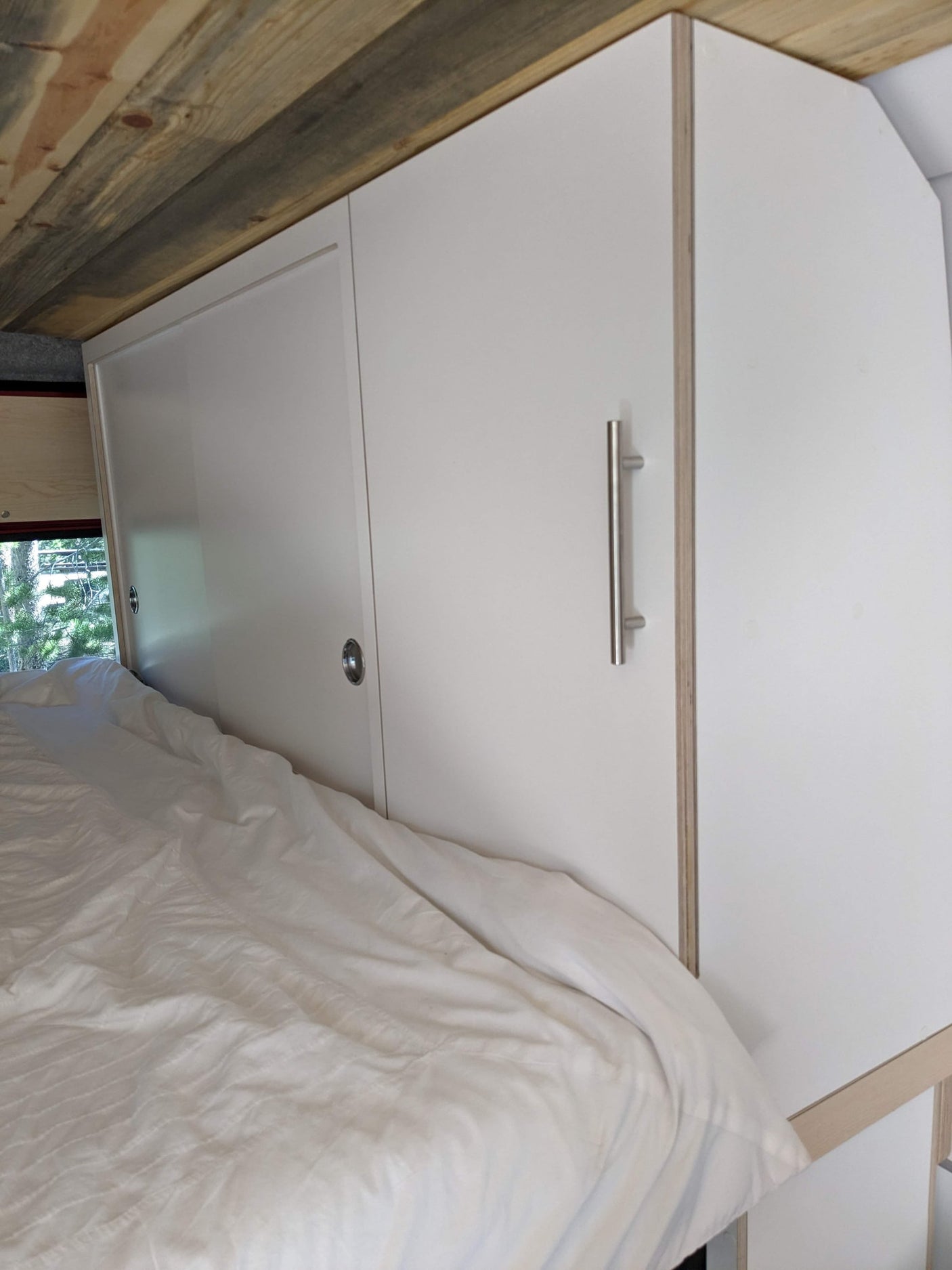 compact adventure home.|RV rental interior: a modern kitchen area featuring white cabinets