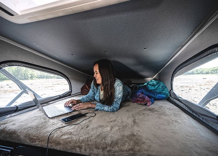 and mirror. Adjacent sleeping area visible for camper comfort.|Get ready for adventure! This RV rental offers a comfortable — photo 14