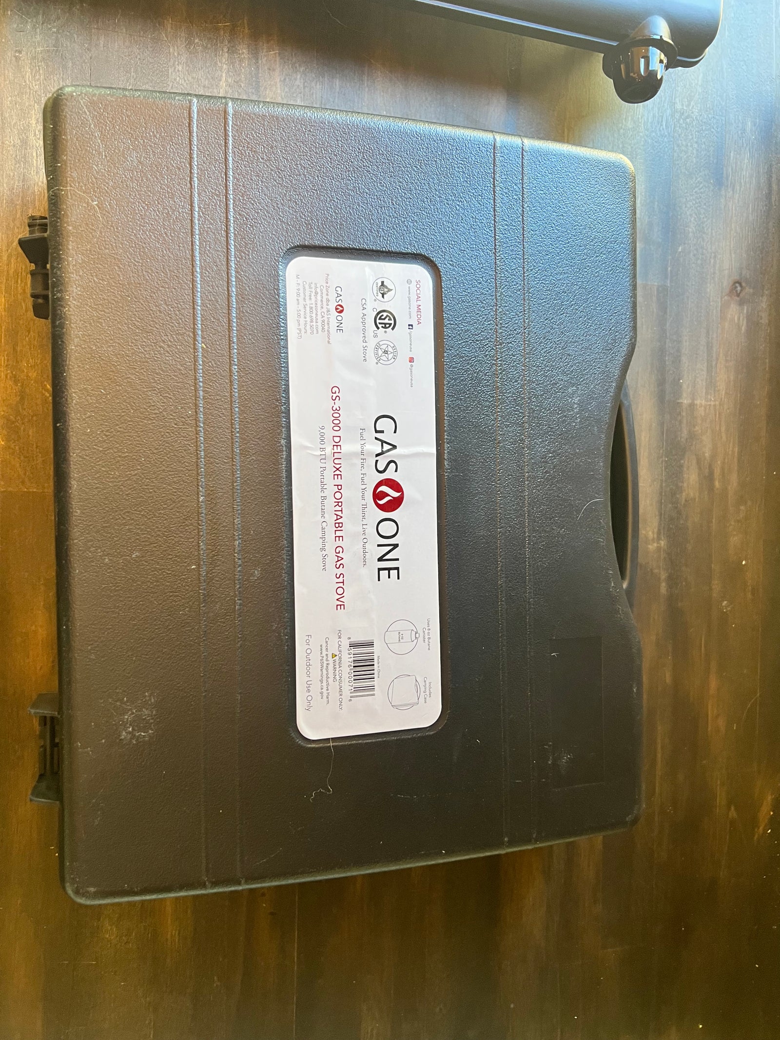 A GASONE GS-3000 portable gas stove in its case, ideal for **RV rental** trips, camping, and outdoor cooking.