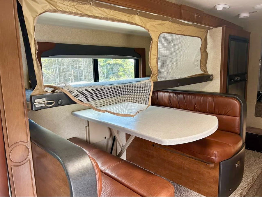 is ready for adventure. Open door & outdoor step visible.|This RV rental features a bright interior with a dining booth