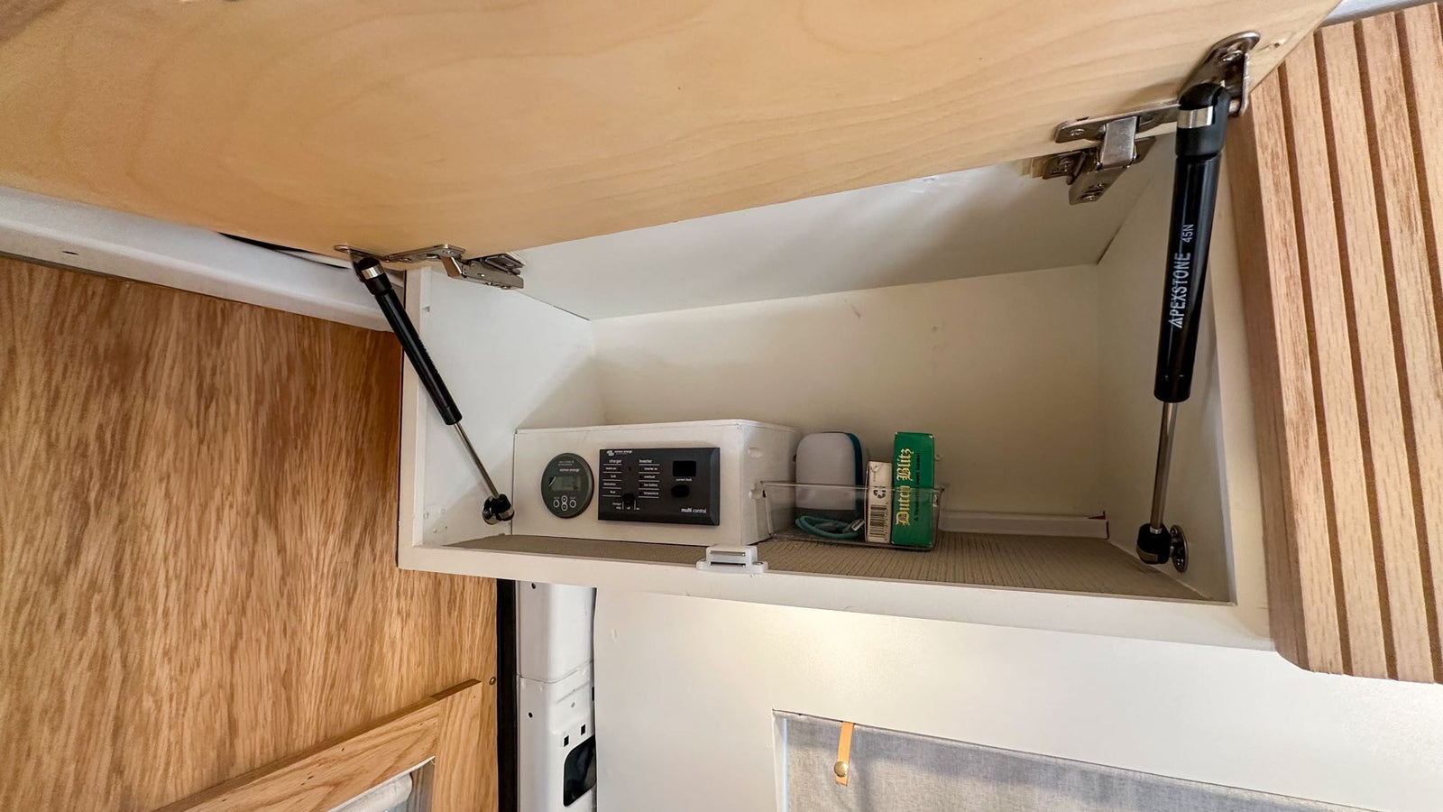 kitchen with tiled backsplash & gold faucet. Cozy mobile living.|Cleverly designed RV rental interior featuring a modern kitchen