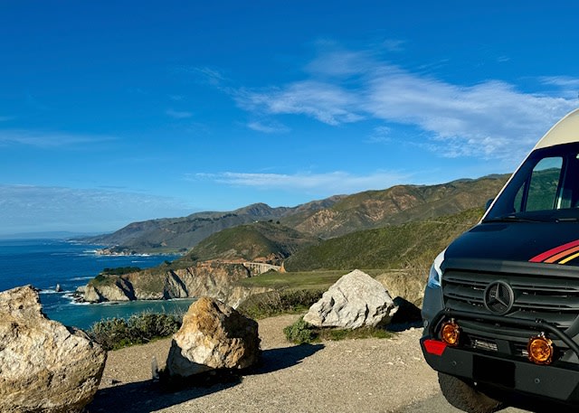 parked in front of majestic snow-capped mountains.|Adventure-ready RV rental in a serene forest campsite. Customized camper van under tall trees
