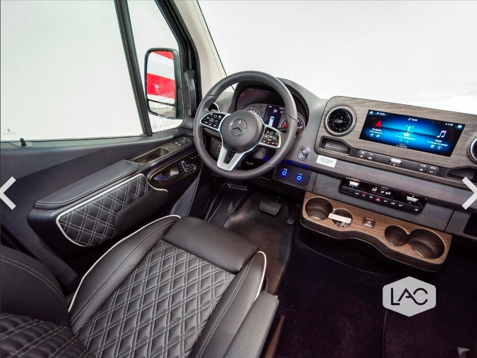 Luxury rv rental interior: detailed cockpit with quilted leather seats, wood trim, and a modern Mercedes-Benz dashboard.