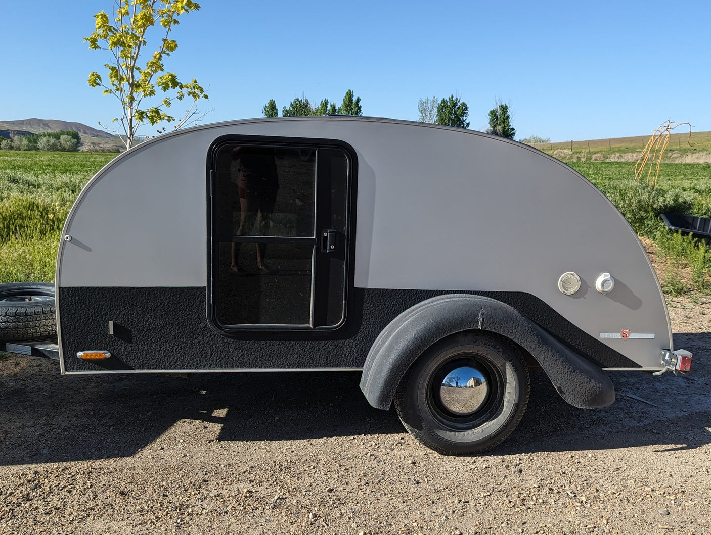 and a bright campfire.|Outdoor adventure: **RV rental** teardrop trailer kitchen