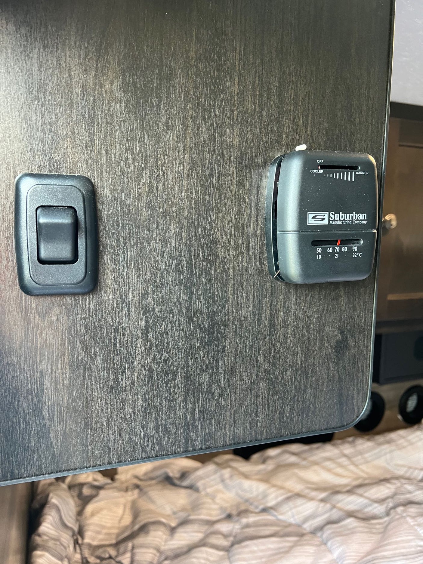 and storage visible through the open door.|Spacious RV rental interior featuring a cozy bed