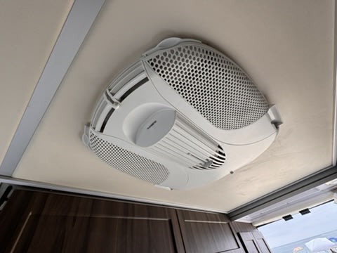 Overhead RV rental AC unit with a modern, perforated design, ensuring cool comfort inside the vehicle.