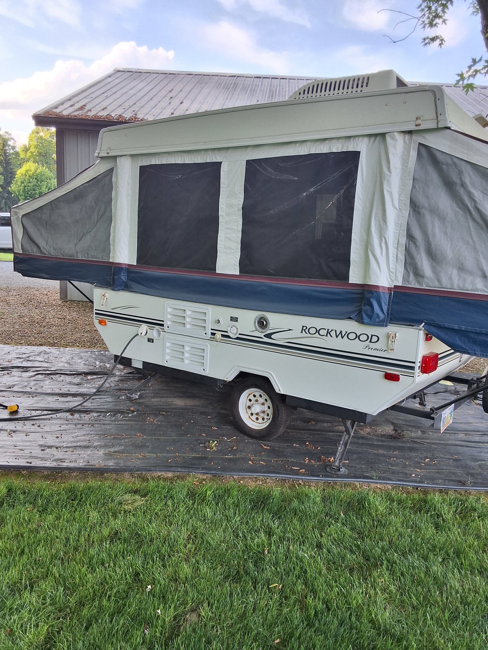 A Rockwood Premier pop-up camper, fully set up for RV rental. Perfect for your camping adventure and outdoor fun.
