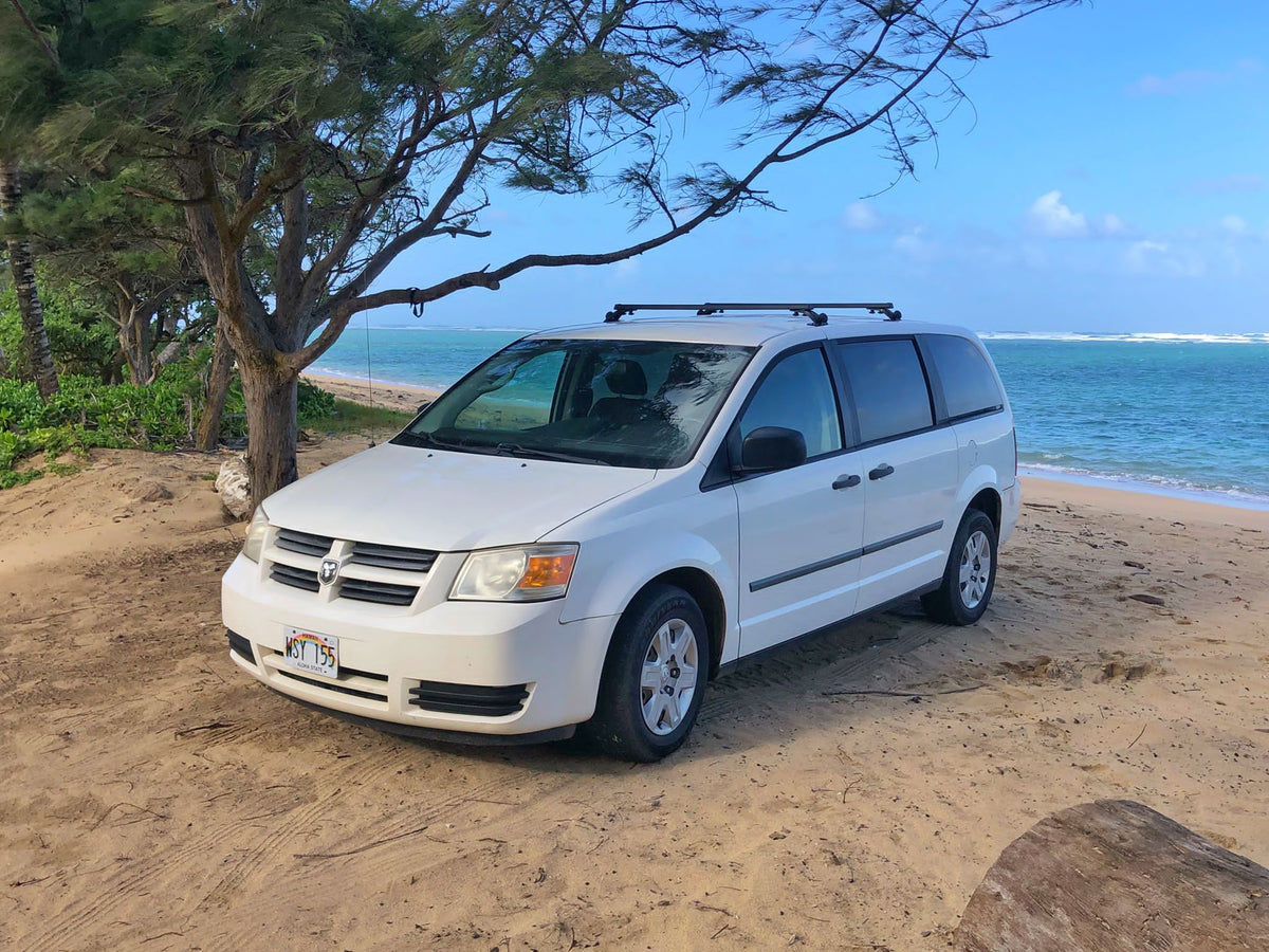 White rental minivan on a Hawaii beach, offering RV rental convenience for island adventures. — photo 5